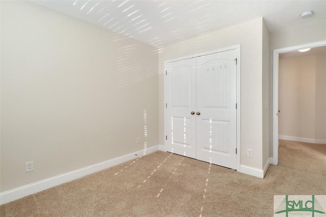 unfurnished bedroom featuring a closet and carpet