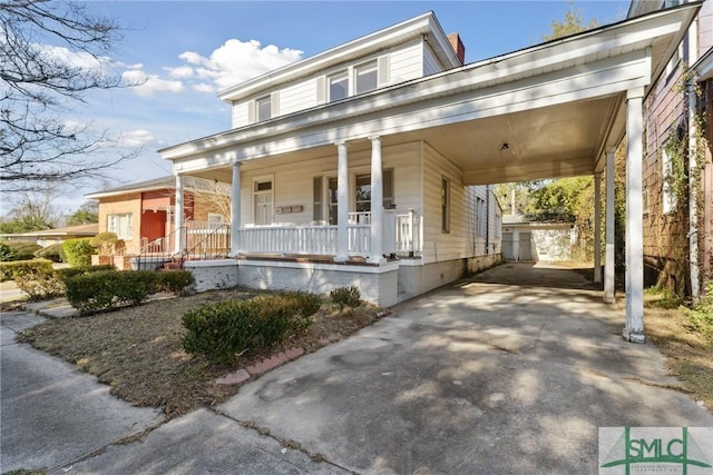 view of front of house featuring covered porch and a carport