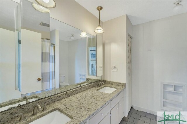 bathroom with tile patterned floors, toilet, and vanity