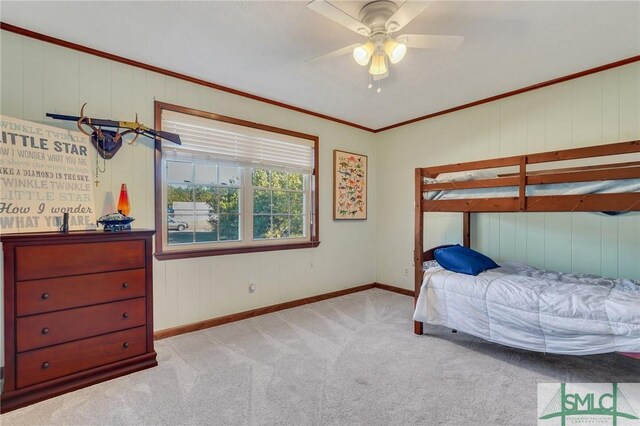 carpeted bedroom featuring crown molding and ceiling fan