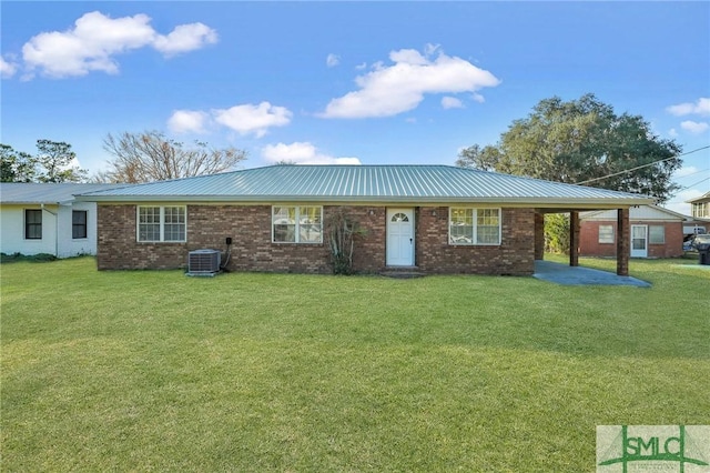 view of front facade with central AC unit, a front yard, and a carport