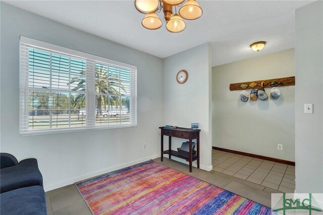 living area with tile patterned flooring and an inviting chandelier