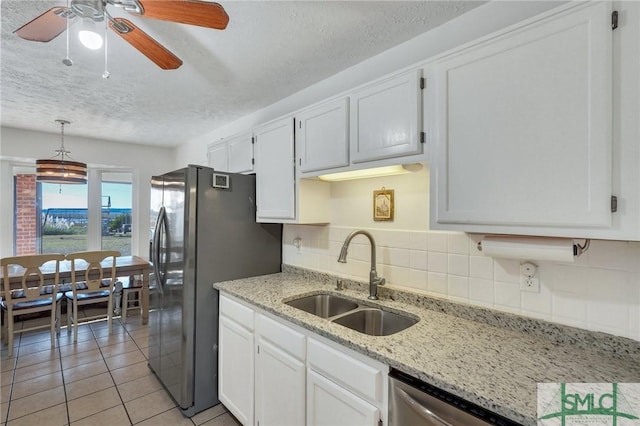 kitchen featuring white cabinetry, sink, and backsplash