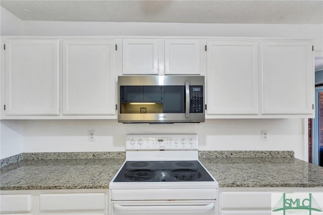 kitchen with white cabinetry, light stone countertops, and white electric range oven