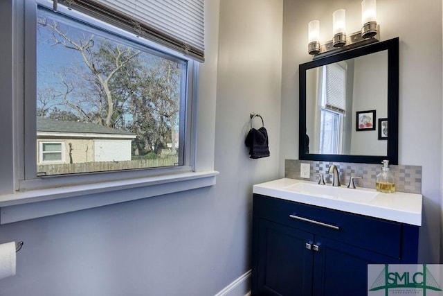 bathroom with vanity and decorative backsplash