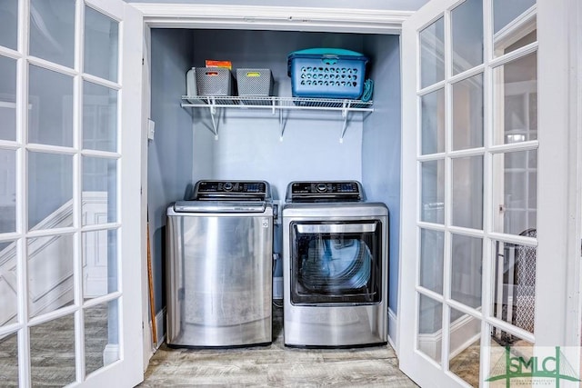 laundry area featuring hardwood / wood-style floors and independent washer and dryer