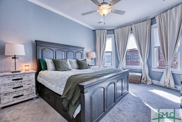 carpeted bedroom with ornamental molding and ceiling fan