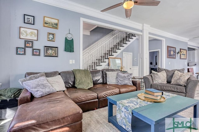 living room with ceiling fan and crown molding