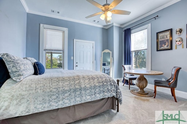 bedroom with ceiling fan, crown molding, and carpet floors