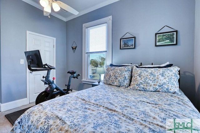 carpeted bedroom with ceiling fan and crown molding