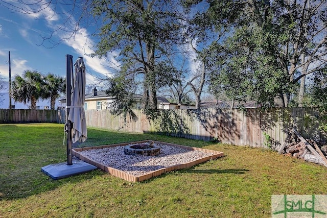 view of yard with a fire pit