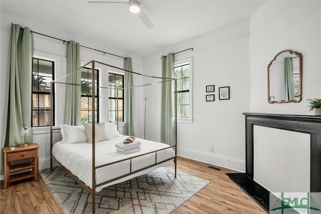 bedroom with ceiling fan and light hardwood / wood-style floors