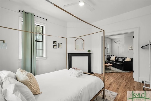 bedroom featuring ceiling fan, light hardwood / wood-style floors, and a closet