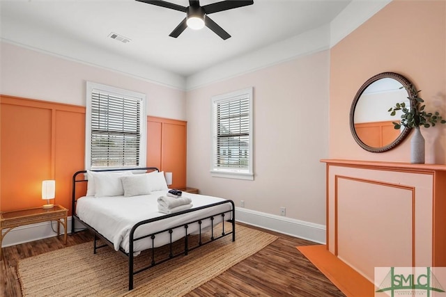 bedroom with dark hardwood / wood-style flooring and ceiling fan