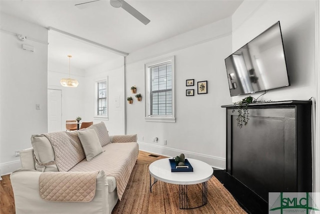 living room with hardwood / wood-style flooring and ceiling fan