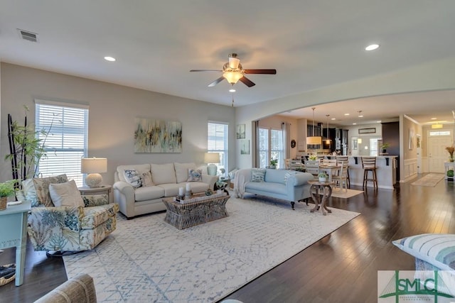 living room featuring hardwood / wood-style flooring, ceiling fan, and a wealth of natural light