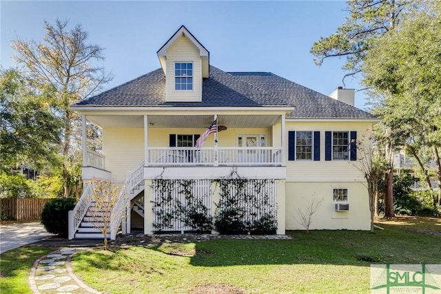 back of house with a porch, cooling unit, and a lawn