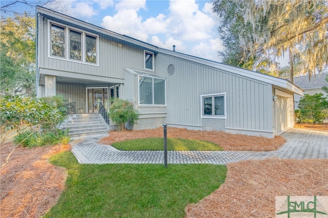 rear view of property with a lawn and a porch