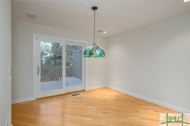 unfurnished dining area featuring hardwood / wood-style flooring