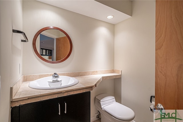 bathroom with toilet and vanity