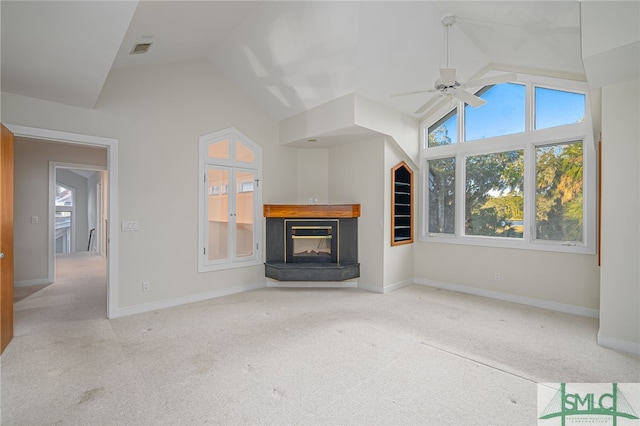 unfurnished living room featuring ceiling fan, lofted ceiling, and light carpet