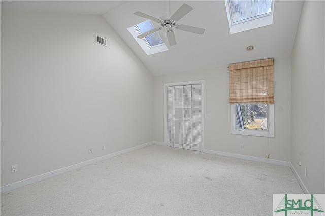 carpeted spare room featuring ceiling fan and lofted ceiling