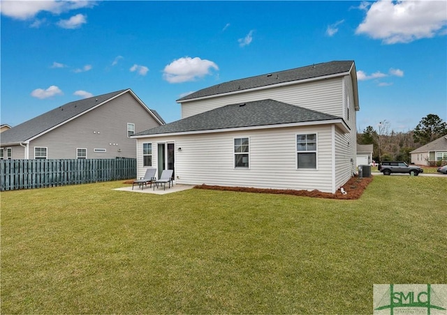 rear view of property featuring a patio, a lawn, and central AC