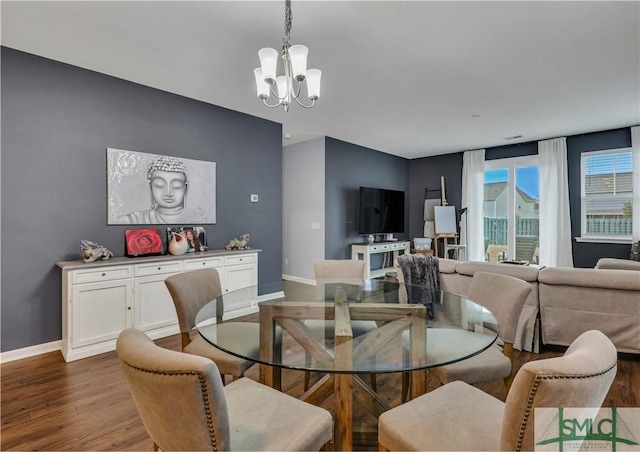 dining space featuring a chandelier and dark hardwood / wood-style floors