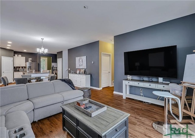 living room featuring hardwood / wood-style floors and an inviting chandelier