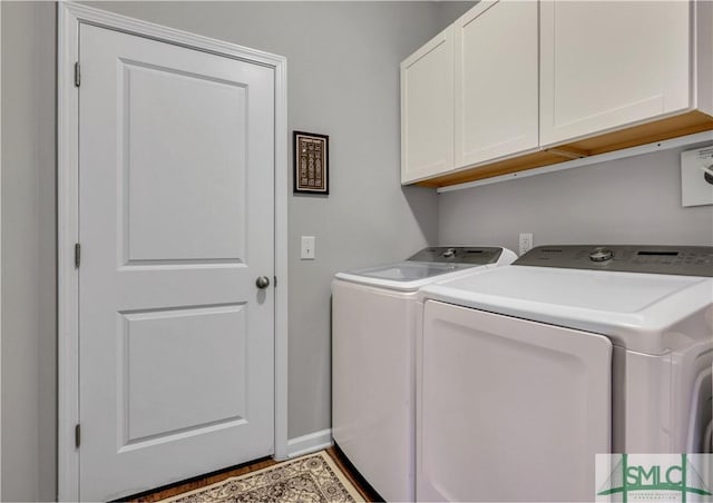 washroom with independent washer and dryer and cabinets