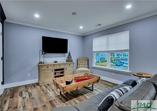 living room featuring ornamental molding and light hardwood / wood-style floors