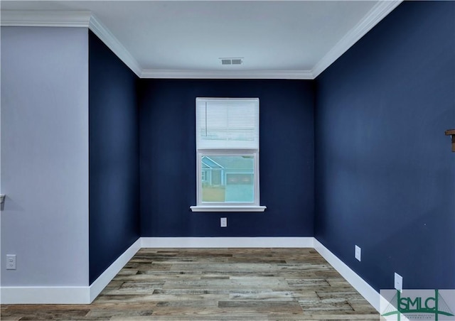 unfurnished room with ornamental molding and light wood-type flooring