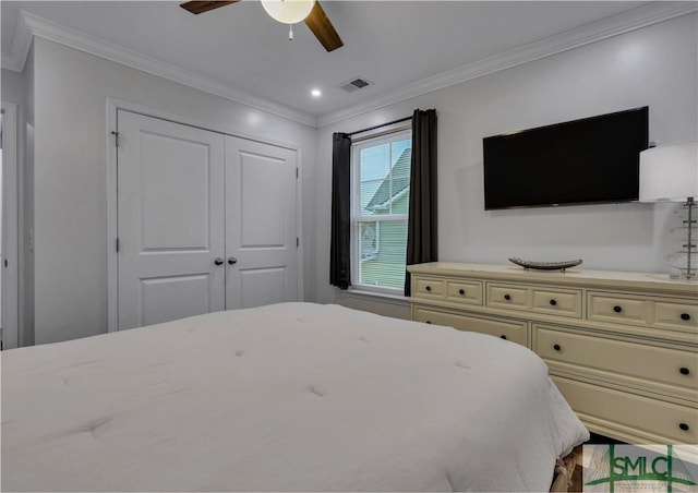 bedroom featuring ceiling fan, a closet, and crown molding