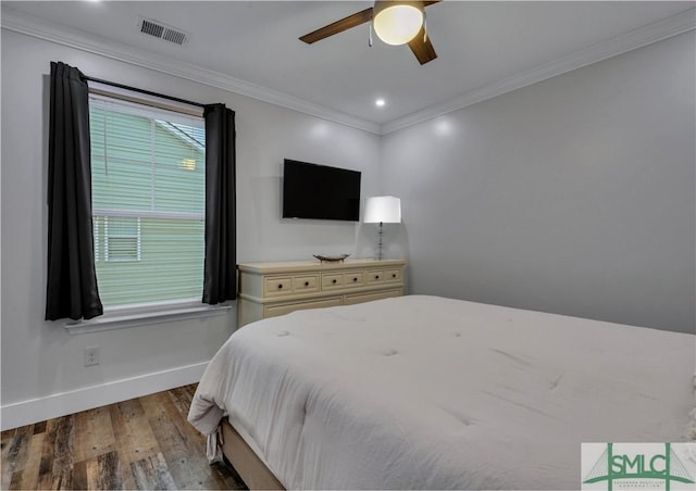 bedroom featuring ceiling fan, hardwood / wood-style flooring, and crown molding