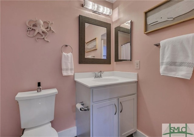 bathroom featuring vanity and toilet