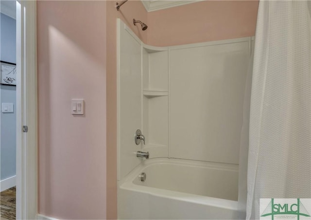 bathroom with ornamental molding and shower / tub combo with curtain