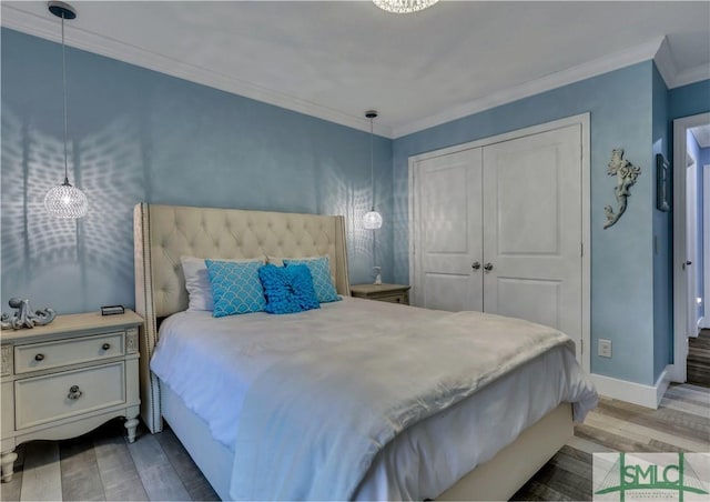 bedroom featuring a closet, crown molding, and hardwood / wood-style flooring