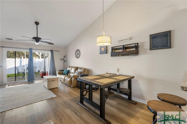 dining room featuring lofted ceiling, ceiling fan, and hardwood / wood-style flooring