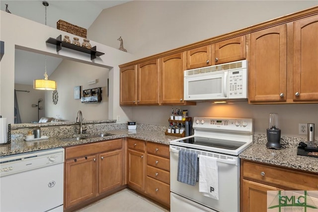 kitchen with sink, vaulted ceiling, white appliances, light stone countertops, and pendant lighting