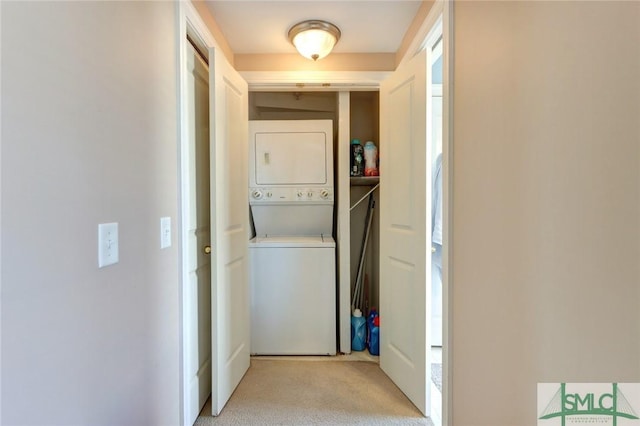 washroom featuring stacked washing maching and dryer and light colored carpet