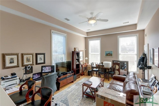 living room featuring ceiling fan and light hardwood / wood-style floors