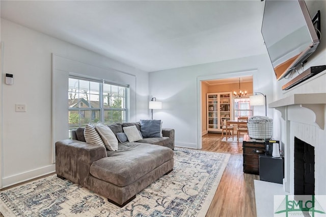 living room featuring a chandelier and light wood-type flooring