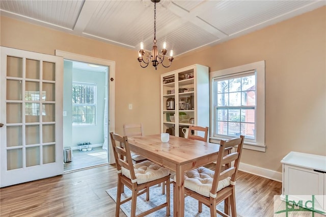 dining area featuring a notable chandelier and light hardwood / wood-style floors