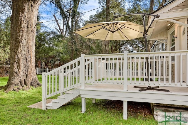 wooden deck featuring a yard