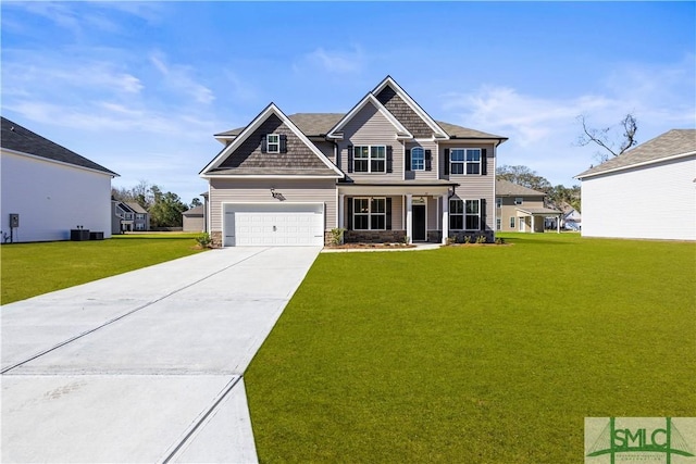 craftsman-style home with a front lawn, stone siding, and driveway