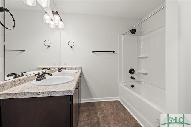 full bathroom with double vanity, baseboards, shower / bathtub combination, and a sink