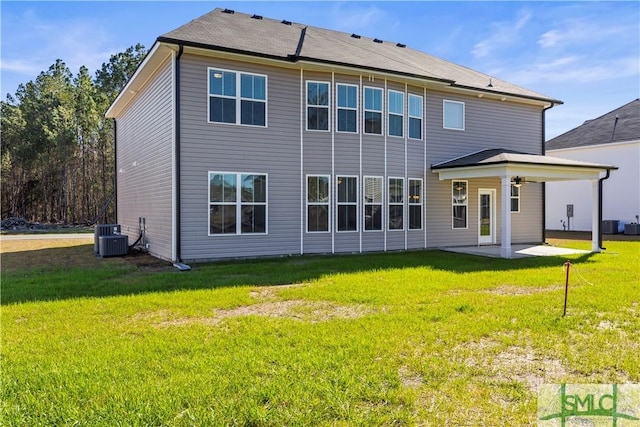 back of house featuring a patio, central AC unit, and a lawn