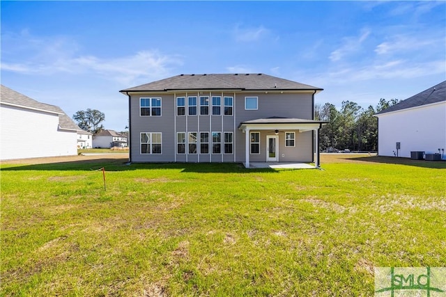 back of property featuring a ceiling fan, a patio, central air condition unit, and a lawn