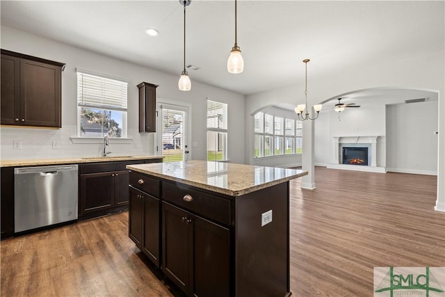 kitchen featuring a sink, tasteful backsplash, dark wood-style floors, dark brown cabinetry, and dishwasher