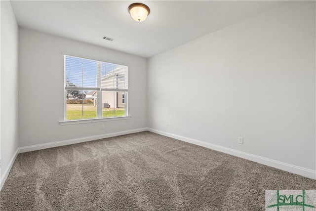 unfurnished room featuring visible vents, baseboards, and carpet